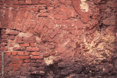 ugly red brick wall background. chaotic street building texture