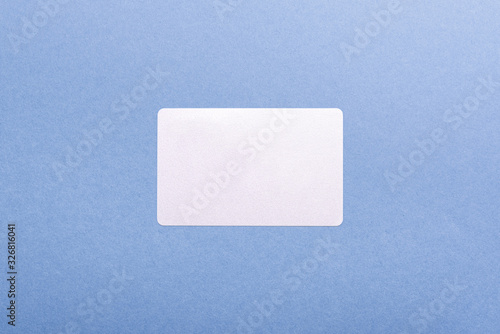 blank card on a blue background with copy space. stickers note for design close-up, top view. blank for discount cards, sales