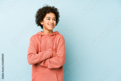 African american little boy isolated smiling confident with crossed arms.