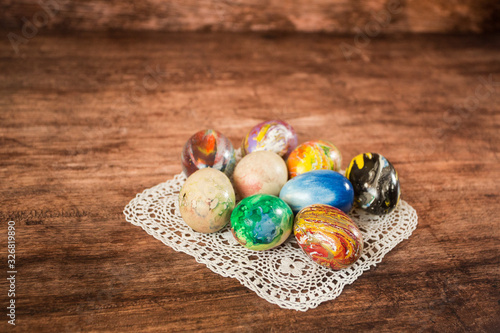 Some Easter eggs in a group on the wooden background. 