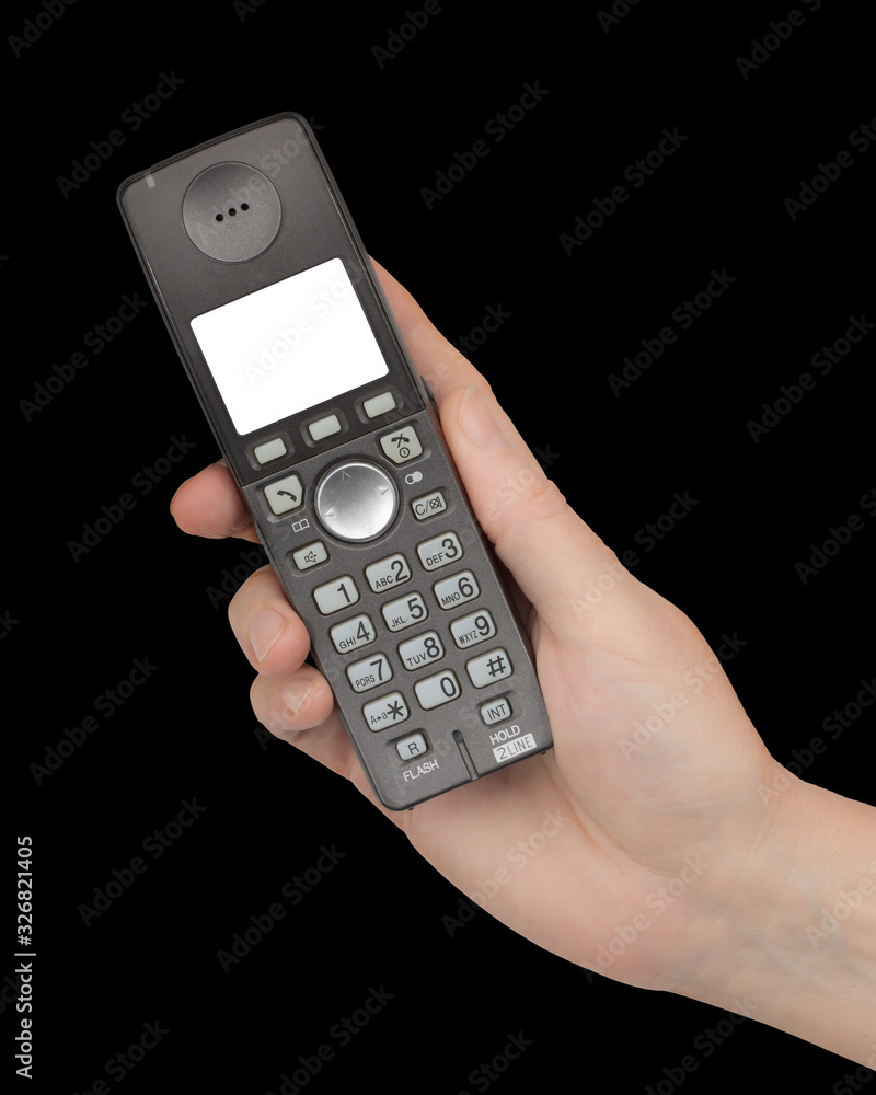 Female hand holds a phone with a white blank screen, isolated on black background Female hand holds a phone with a white blank screen, isolated on black background