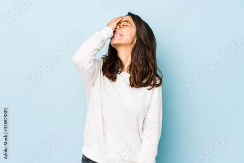 Young mixed race hispanic woman isolated laughing happy, carefree, natural emotion.