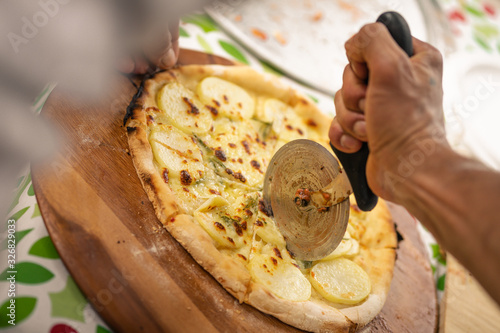 Pizza cutting with warm tones