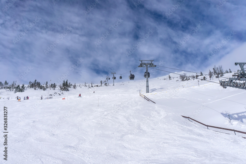 Skiers on a slope in the mountains of Slovakia Skiers on a slope in the mountains of Slovakia