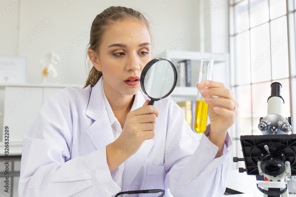 A beautiful female scientist is operating in a science lab with various equipment in the lab. A beautiful female scientist is operating in a science lab with various equipment in the lab.