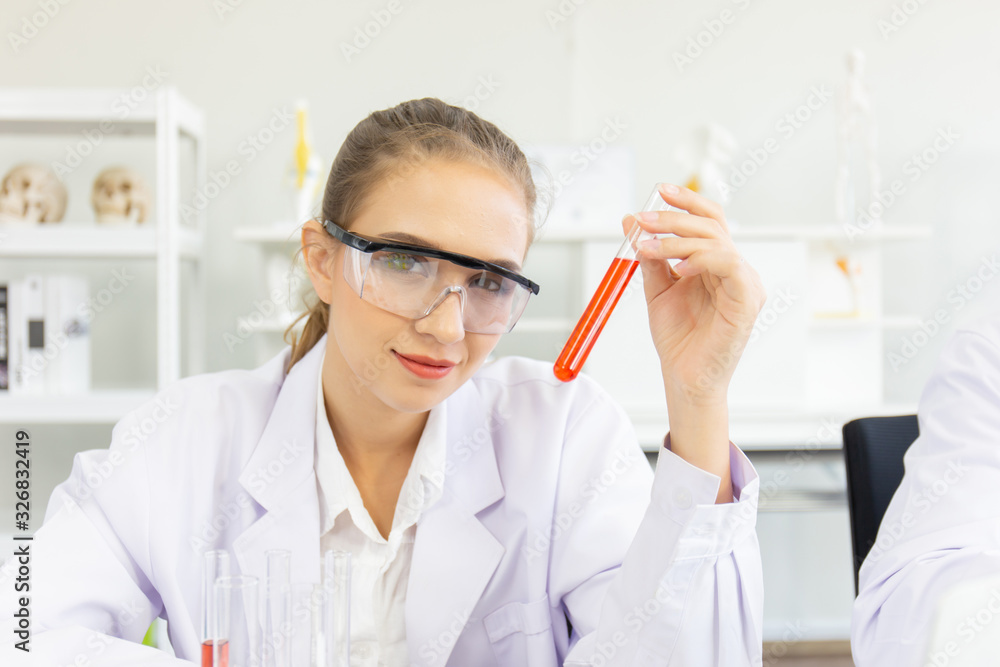 A beautiful female scientist is operating in a science lab with various equipment in the lab. A beautiful female scientist is operating in a science lab with various equipment in the lab.