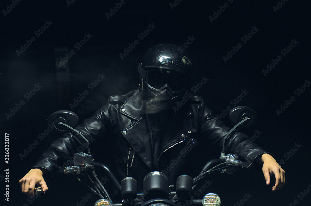 Fototapeta premium motorcyclist with smoke in the dark
