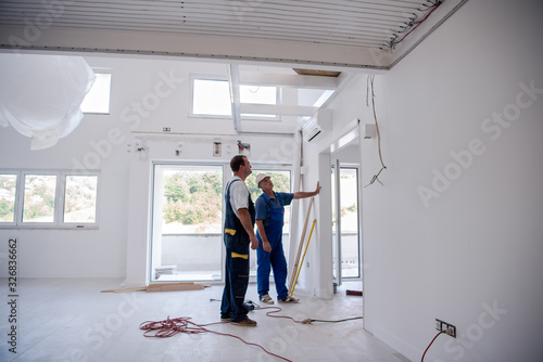 carpenters installing glass door with a wooden frame © .shock