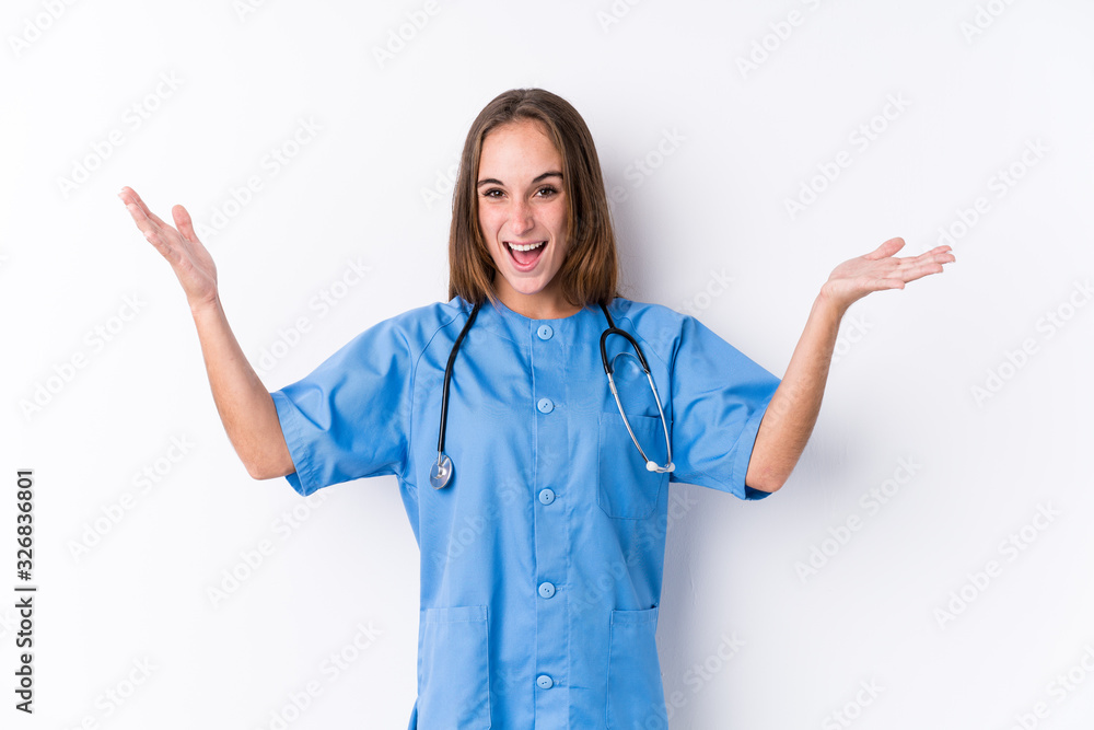 Young nurse woman isolated receiving a pleasant surprise, excited and raising hands. Young nurse woman isolated receiving a pleasant surprise, excited and raising hands.