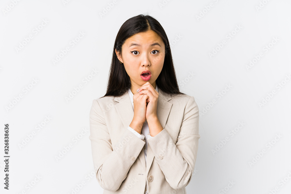 Young chinese business woman isolated praying for luck, amazed and opening mouth looking to front. Young chinese business woman isolated praying for luck, amazed and opening mouth looking to front.