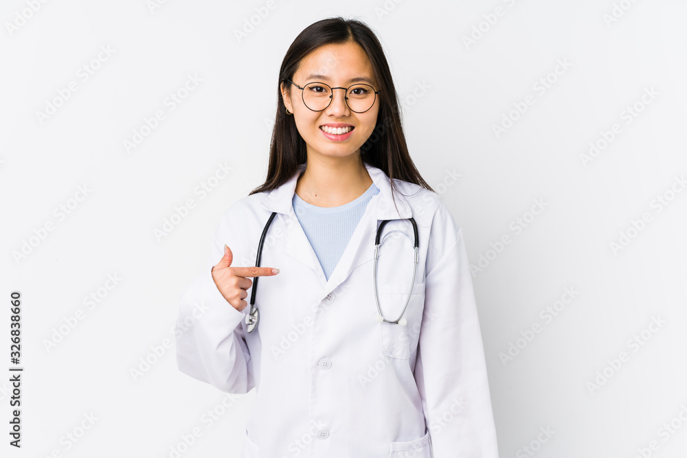 Young doctor chinese woman isolated person pointing by hand to a shirt copy space, proud and confident Young doctor chinese woman isolated person pointing by hand to a shirt copy space, proud and confident