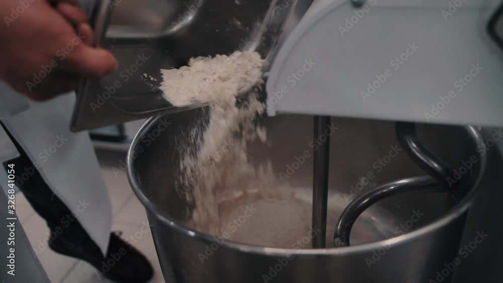 chef sprinkles salt in dough in the kitchen1 chef sprinkles salt in dough in the kitchen1