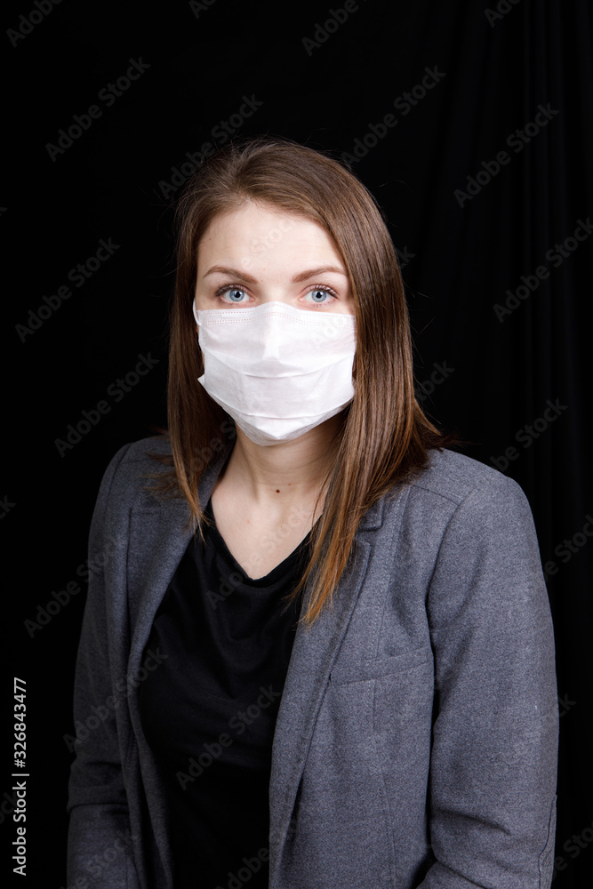 Coronavirus in China. Novel coronavirus (2019-nCoV), woman in white medical face mask. Concept of coronavirus quarantine Coronavirus in China. Novel coronavirus (2019-nCoV), woman in white medical face mask. Concept of coronavirus quarantine