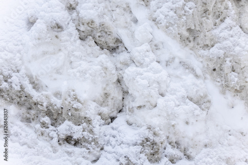 Dirty snow spring background. Spring time. Old and dirty snow texture. Natural background