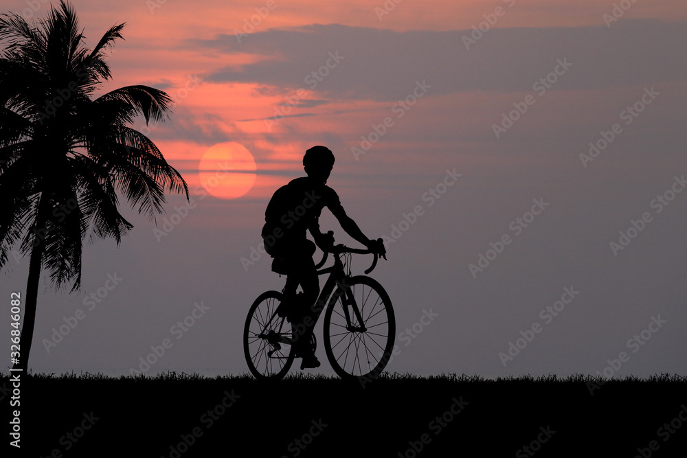 Fototapeta premium Silhouette Cycling on blurry sunrise sky background.