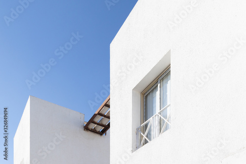 Minimal background in architectural style. White walls against the blue sky.