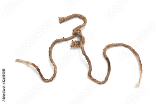 Old dirty twine rope on a white background.