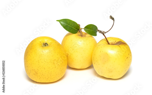 Ripe yellow apple isolated on a white background.