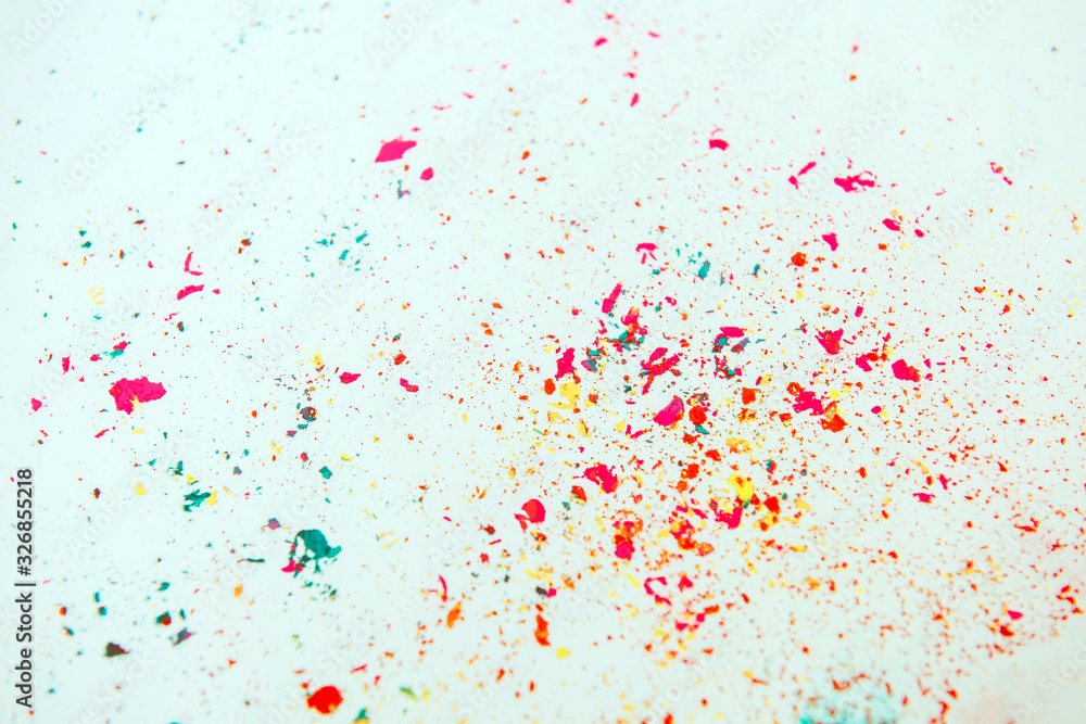 Multi-colored powder paint spread over white background. Holi concept.