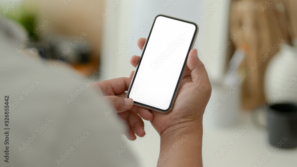 Cropped shot of male designer showing blank screen smartphone Cropped shot of male designer showing blank screen smartphone
