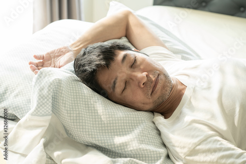 Senior asiam man sleeping on the bed