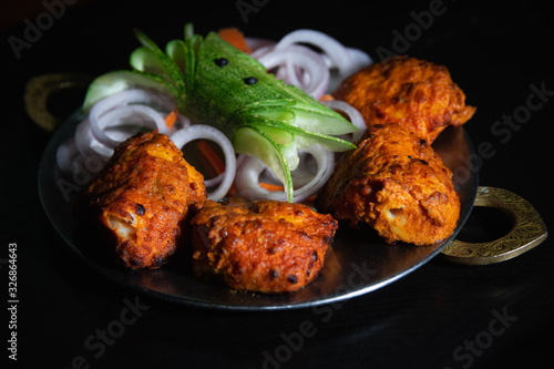 Photography Tawa fish a punjabi recipe as starters served in north indian style plate nicely