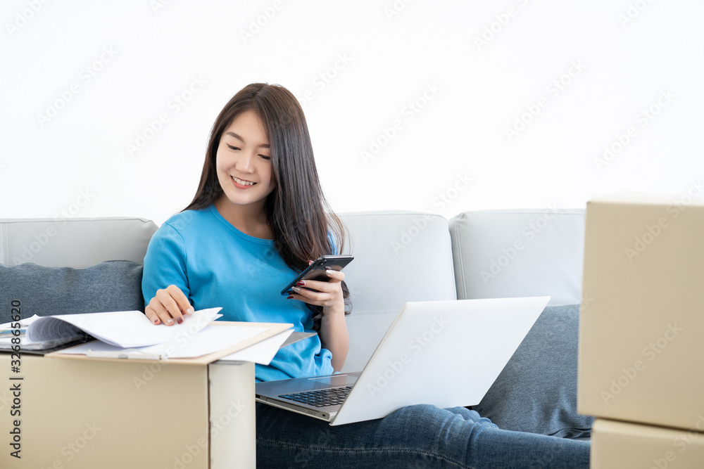 businesswoman working relaxing by laptop computer and mobile phone on sofa at home morning businesswoman working relaxing by laptop computer and mobile phone on sofa at home morning