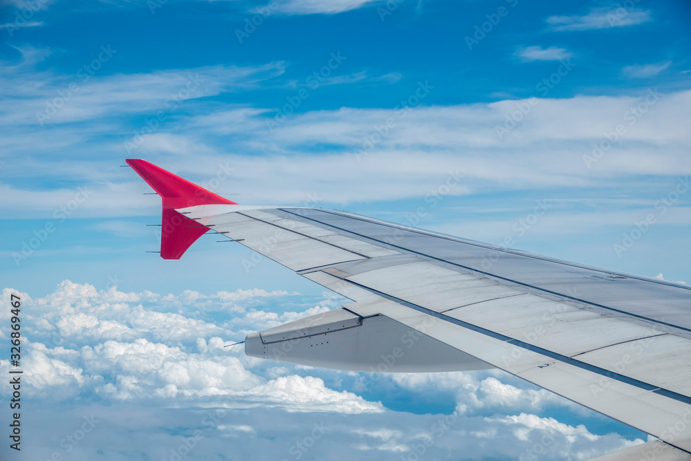 Look through the plane window and white cloud and blue sky Look through the plane window and white cloud and blue sky