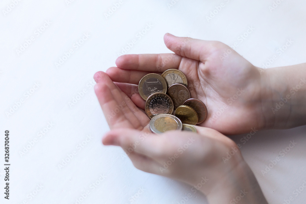 A handful of coins in the palm of hands. Euro coins on a white background A handful of coins in the palm of hands. Euro coins on a white background