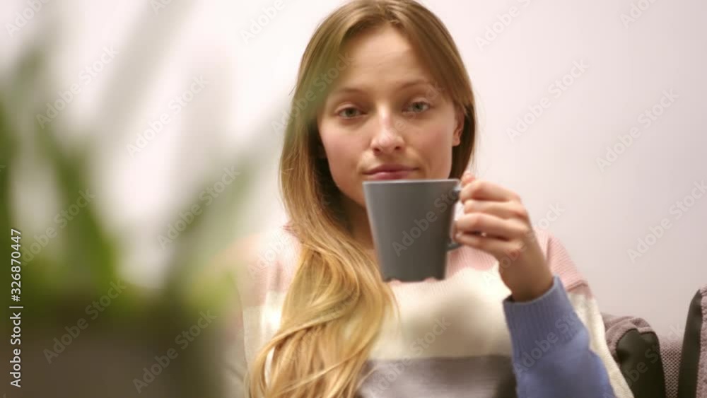 A lovely woman enjoying drinking her morning coffee - medium shot A lovely woman enjoying drinking her morning coffee - medium shot