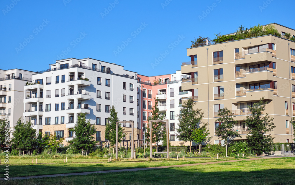 Modern apartment houses with a green park seen in Berlin, Germany