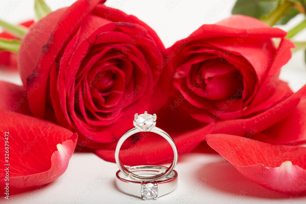 Diamond rings and gift boxes on roses Diamond rings and gift boxes on roses