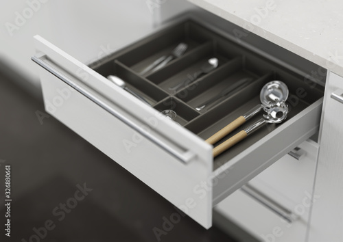 Open kitchen drawer with cooking utensils. Storage and organization of the kitchen. 3d rendering.