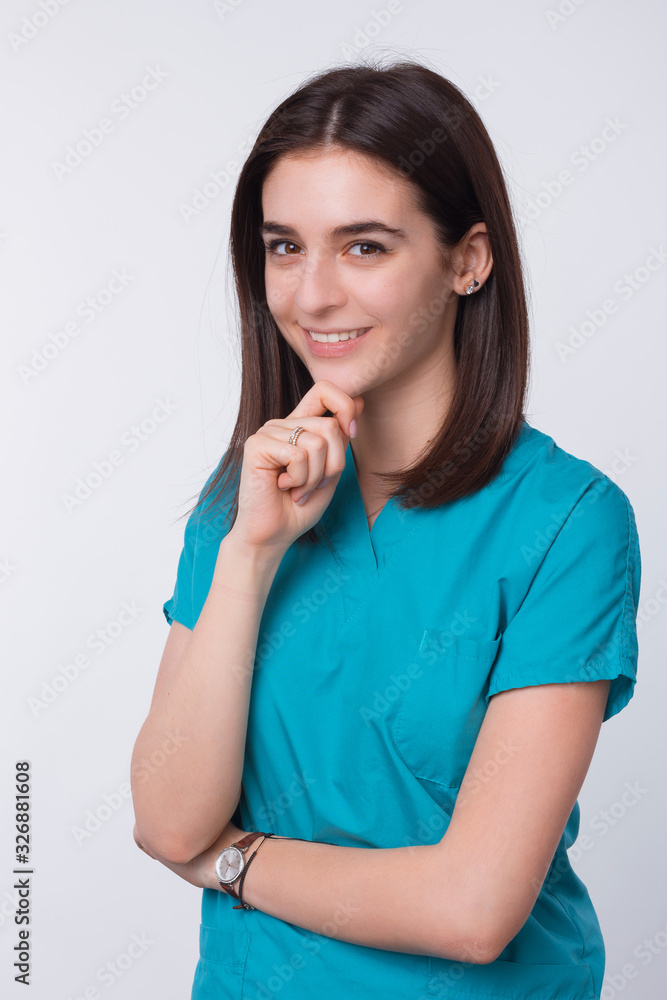 smiling young doctor looking confident at the camera smiling young doctor looking confident at the camera