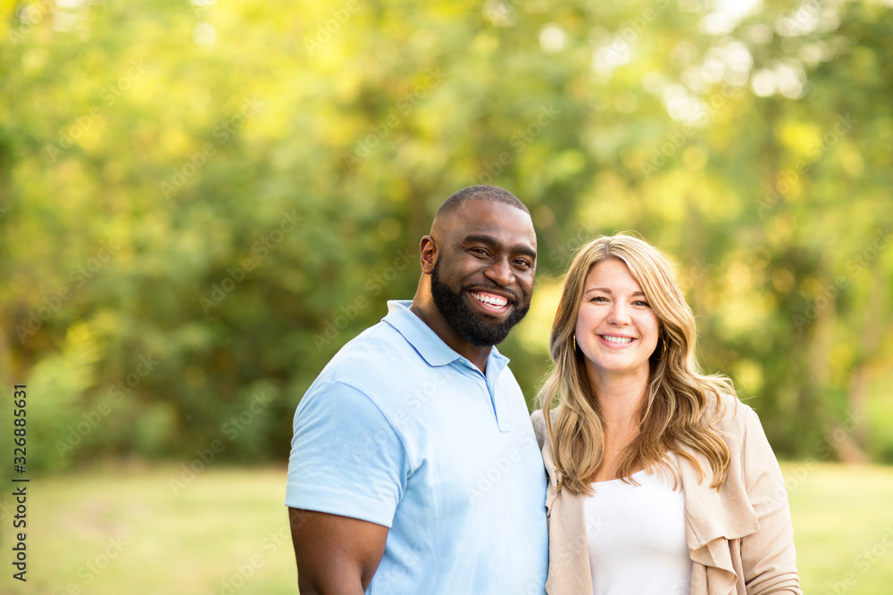 Loving mixed race couple hugging and laughing. Loving mixed race couple hugging and laughing.