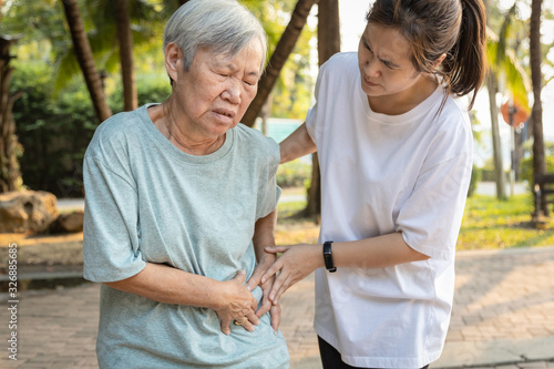 Sick asian senior woman with belly pain,elderly have severe stomach ache,left side,patient with acute pancreatitis hold hand left stomachache,abdominal pain,inflammatory bowel disease,irritable bowel photo