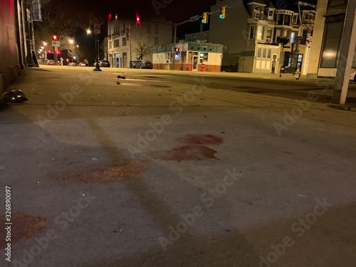 blood on pavement sidewalk foot prints leading to street night (ID: 326890097)