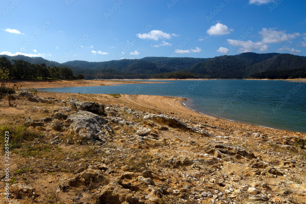 Low water during drought at Lake Tinaroo on the Atherton Tablelands in Queensland, Australia Low water during drought at Lake Tinaroo on the Atherton Tablelands in Queensland, Australia