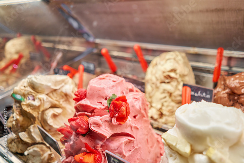 Fruit with strawberries Gelato. Flavors various ice cream in Rome, Italy. Italian gelateria. Assortment of colorful gelato on cafe showcase. Natural fresh ice cream.