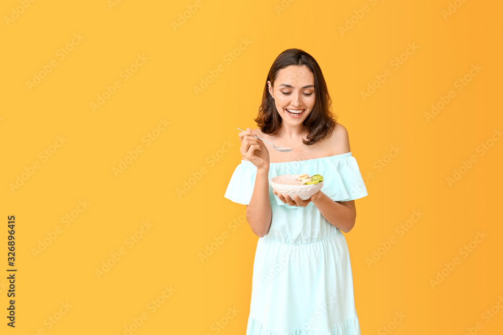 Young woman with tasty yogurt on color background Young woman with tasty yogurt on color background