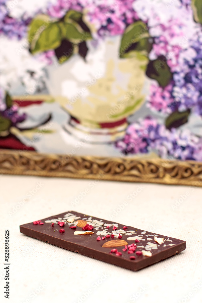 Handmade dark chocolate bar with a variety of dried fruit and nut toppings Handmade dark chocolate bar with a variety of dried fruit and nut toppings