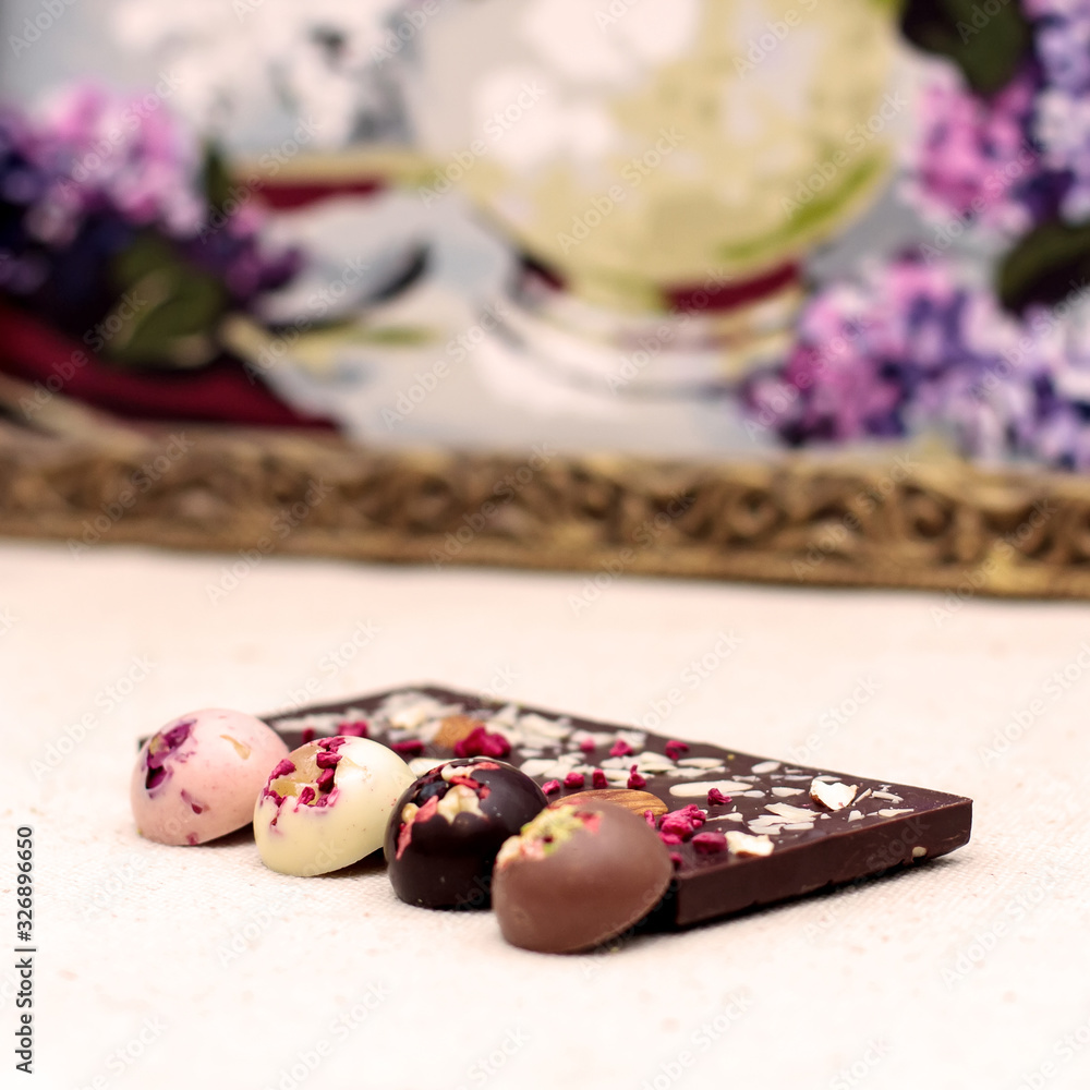 Handmade dark chocolate bar with a variety of dried fruit and nut toppings Handmade dark chocolate bar with a variety of dried fruit and nut toppings