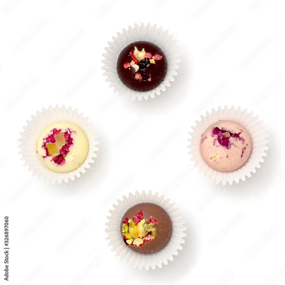Handmade chocolate candies with a variety of dried fruit and nut toppings