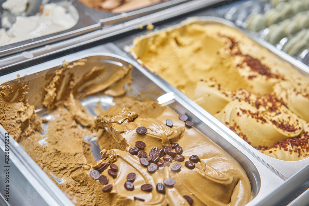 Coffee Gelato. Flavors various ice cream in Rome, Italy. Italian gelateria. Assortment of colorful gelato on cafe showcase. Natural fresh ice cream. Coffee Gelato. Flavors various ice cream in Rome, Italy. Italian gelateria. Assortment of colorful gelato on cafe showcase. Natural fresh ice cream.