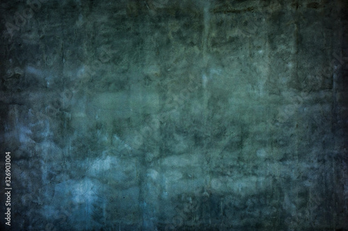 Grunge dark aged wall plaster texture background.