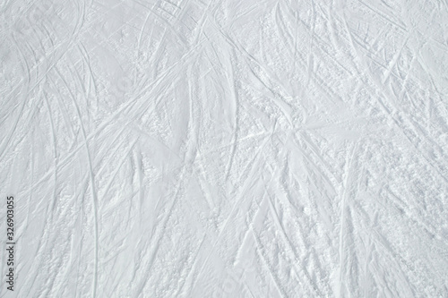 Top view of ski tracks on snow background.