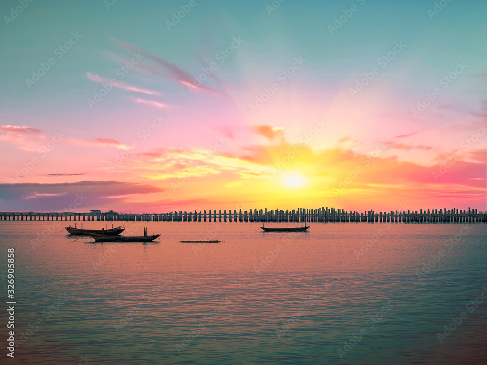 Coastal landscape with a fishing boat on sun set.