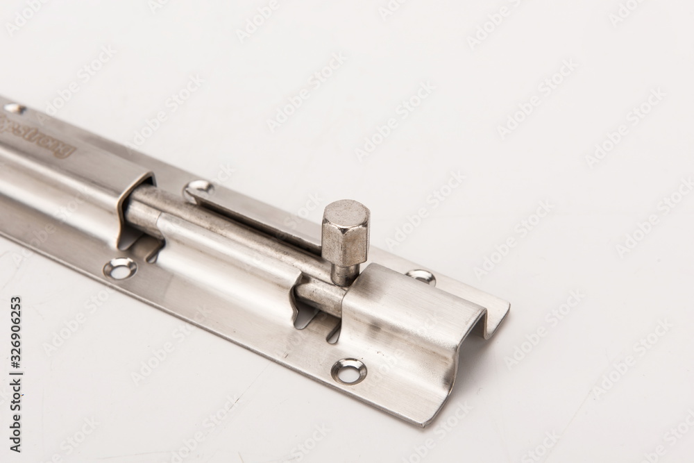 The simple silver metal deadbolt against a white background The simple silver metal deadbolt against a white background