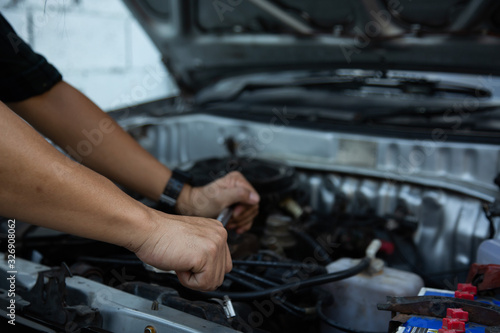 Men are using hands to change the car engine oil to extend the service life.