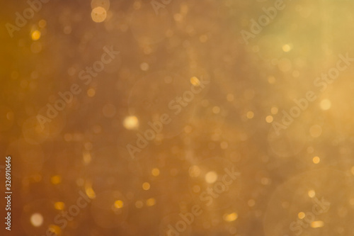 Dark Abstract Gold bokeh sparkle on black background